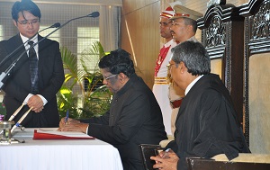 The Governor of Arunachal Pradesh Shri V. Shanmuganathan signing oath paper in presence of Hon�ble Chief Justice of Gauhati High Court Mr. Justice Shri Ajit Singh. Also seen:  Secretary to Governor Dr. Joram Beda in the Darbar Hall of Raj Bhavan, Itanagar on 14th September� 2016.